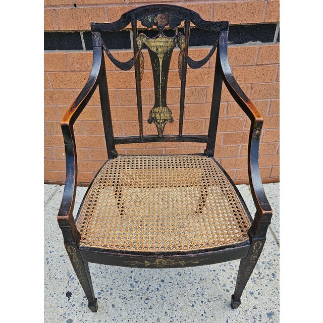 A very distinctive, structurally sound 18th Century Ebonized, Inlaid and Decorated Cane Seat Armchair measuring 20.5" in...