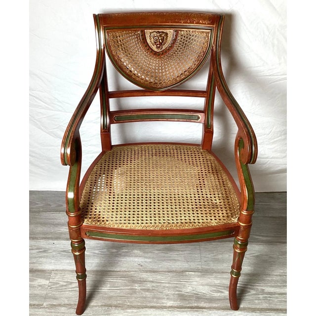 A Classic English Regency hand painted arm chair. Made by the expert cabinet maker, Smith and Watson NYC. The cane seat...