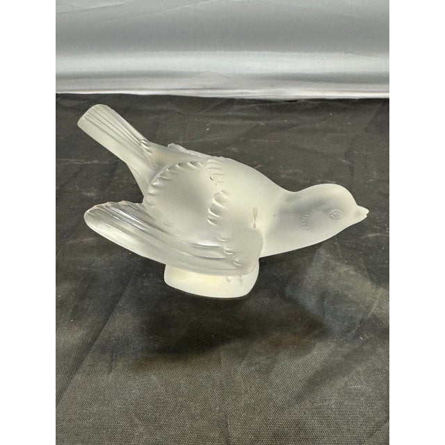 The Lalique France Frosted Crystal Sparrow "Coléreux" Angry Bird Figurine #11633 is a collectible figurine of a hand-...