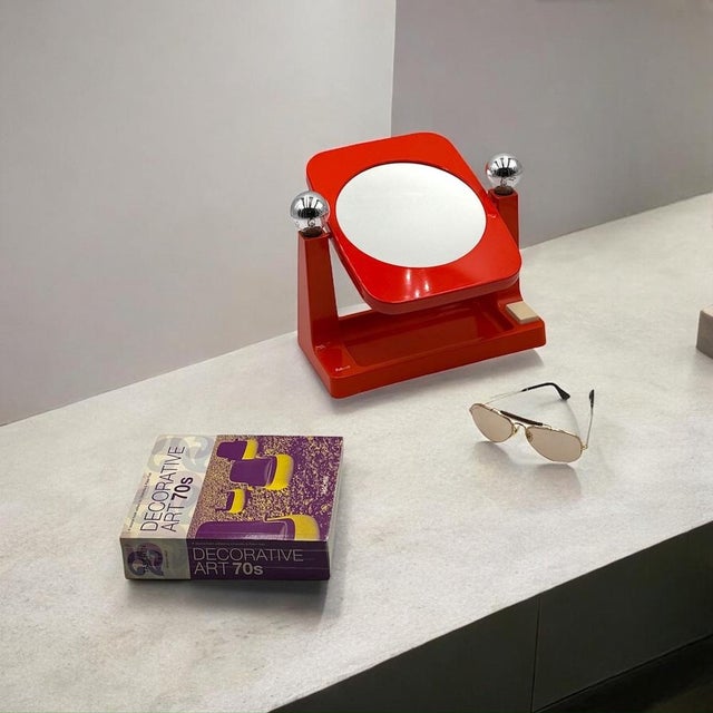 Step back into the dazzling 1970s with this vibrant space age mirror by Schott, West Germany! This bold orange plastic...