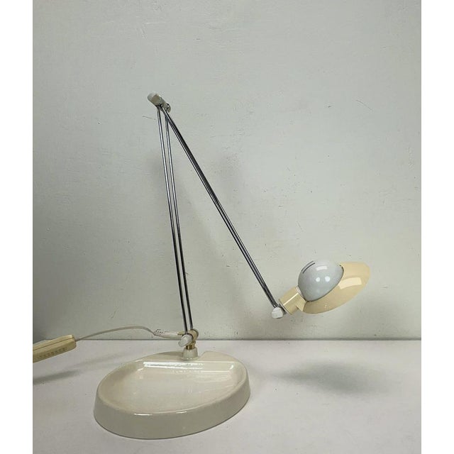 Danish Design desk lamp with enamelled cast iron base and a lampshade in baseball cap shape. The lamp is rotatable and...