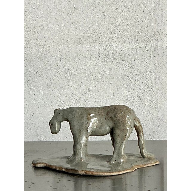 Presenting a captivating vintage glazed ceramic tiger figurine, a unique piece of handcrafted artistry that embodies a...