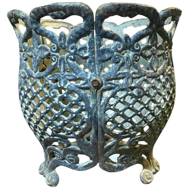 Three beautifully patinated reticulated cast iron jardinieres on scrolled feet.