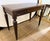 Handsome Ethan Allen custom writing desk featuring a rich Nightfall finish, architectural Avery legs and antique brass...