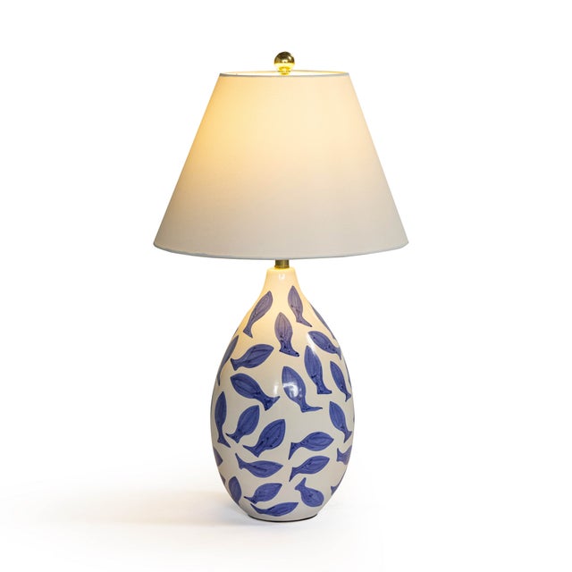 Add a touch of artful whimsy to your space with the Sardine Table Lamp. Its hand-painted ceramic base features playful...