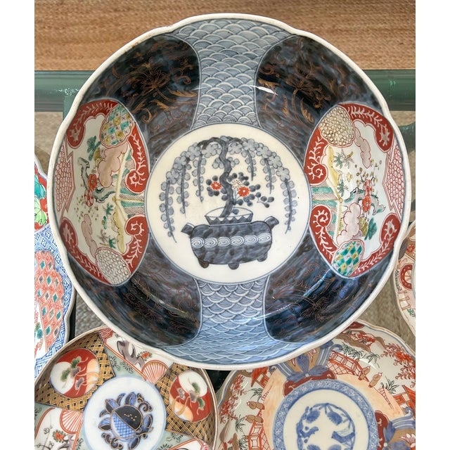 A handsome antique Japanese Imari porcelain center bowl decorated in the traditional palette of underglaze cobalt blue,...