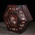 A beautifully crafted Chinese hexagonal box, likely made of Zitan wood. The piece features a faceted, domed lid that opens...