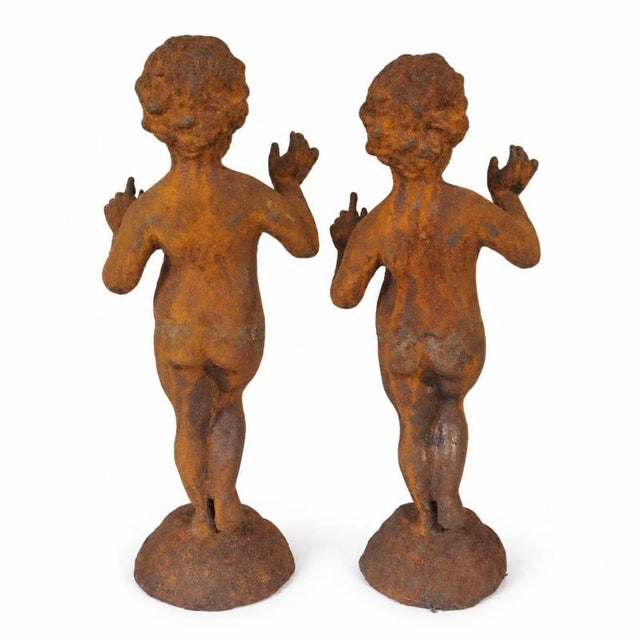 Pair of dancing putti sculptures in cast iron - late 19th century. Pair of decorative sculptures representing putti or...