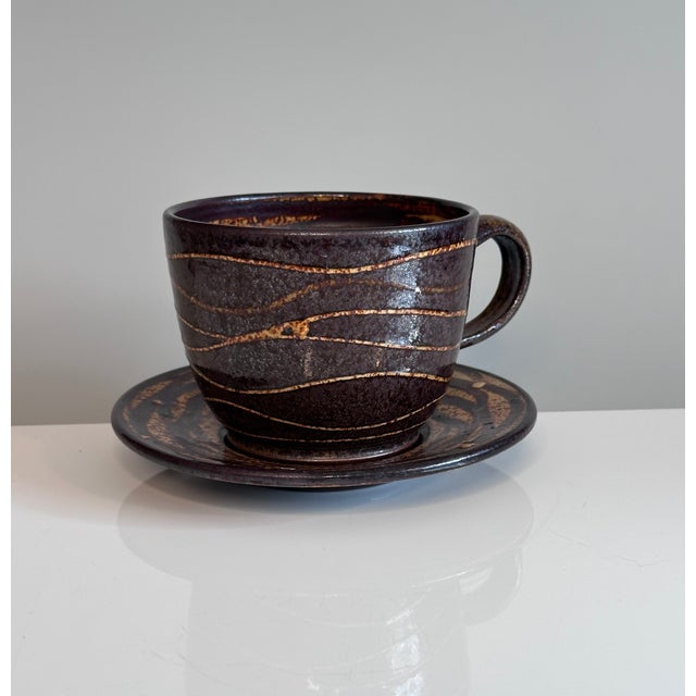 A high-quality studio ceramic art cup with saucer, created by the renown German ceramic artist Helma Klett (1908-1996)...