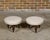 A pair of English mahogany stools from the 19th century with turned legs resting on casters and upholstered seats. This...