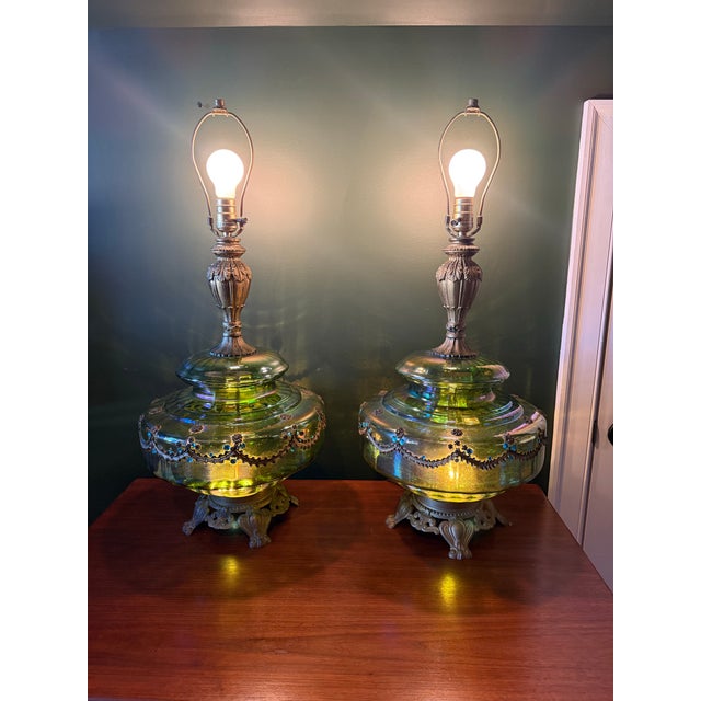Stunning pair of vintage table lamps featuring oversized green pearlescent glass bodies with beautiful iridescent finishes...