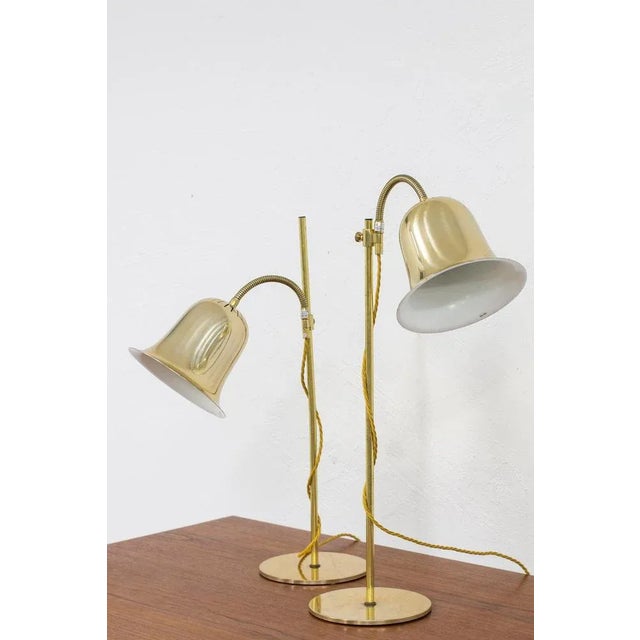 Pair of table lamps produced in Sweden by Trivselbelysning AB. Made from Brass and aluminum. Adjustable in angle and in...