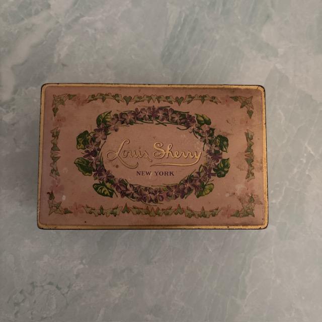 Lovely tin collectible box by Louis Sherry of New York. Once held delicious chocolates, now a pretty keepsake for dried...