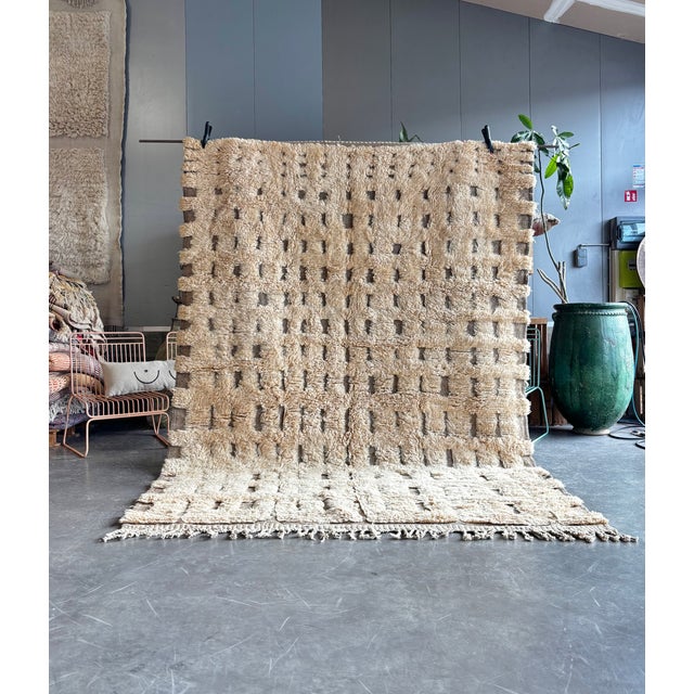 This Moroccan Mrirt Beni Ouarain rug is a handwoven piece crafted by skilled artisans from the Middle Atlas region of...