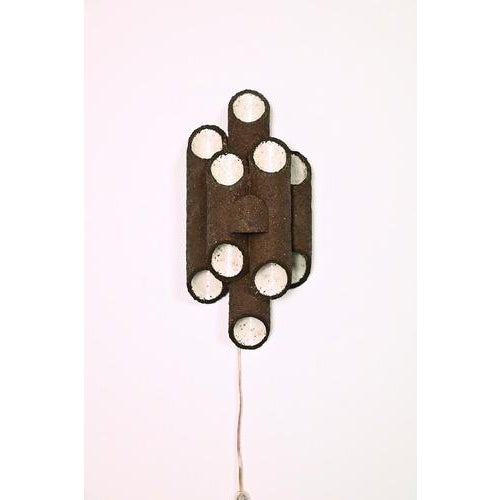 Danish 70s wall sconce. Signed handmade ceramic. The lamp is made from coarse clay and partially glazed in white. The...