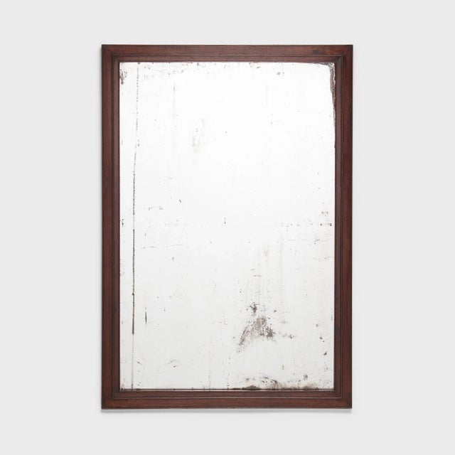 This antique Chinese wall mirror is framed in fine hardwood and set with its original silvered glass, spoiled over time....