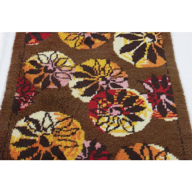 Hand-knotted in lush, high-pile wool in Sweden circa 1960-1970, this 3x6 vintage Swedish Rya runner is a bold new addition...