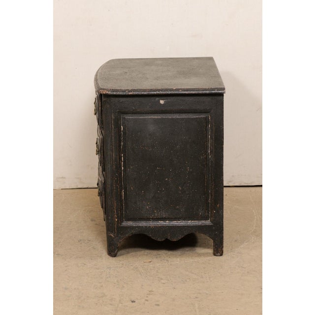 A French Louis XV chest of drawers from the 18th century. This antique commode from France, with is subtle curves and...