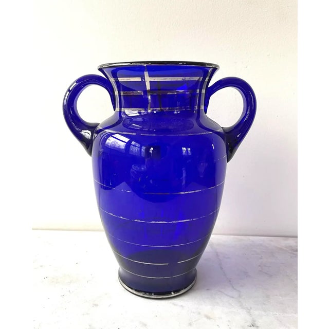 Gorgeous early 20th century rich cobalt blue glass urn vase with painted silver trim design.