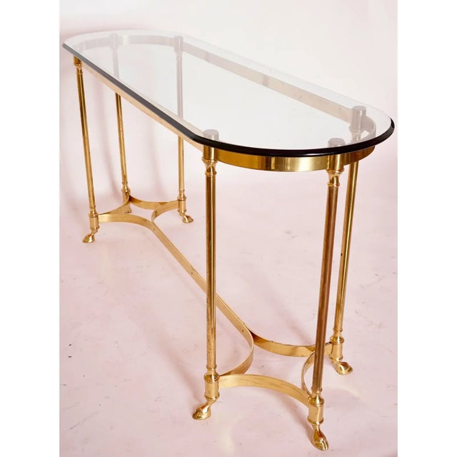 A Vintage 1980 Brass Console Table, hoofed feet style. Made in Canada for LaBarge. Polished brass. In perfect condition....