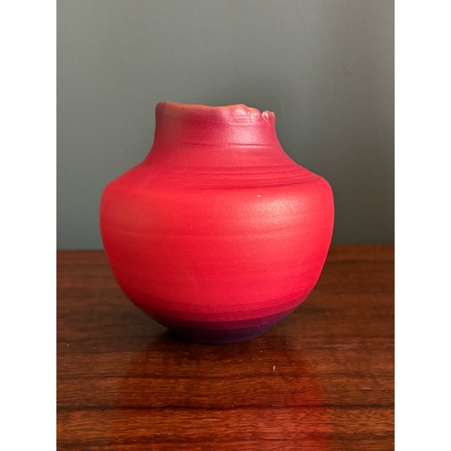 This is a stunning iridescent red artisan hand-thrown pottery vase by renowned pottery and artist Tom Krueger. Krueger...