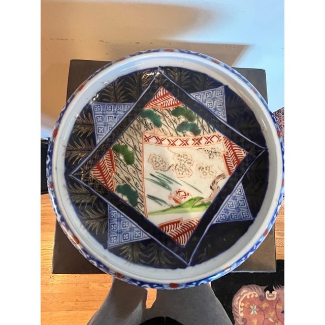 This is a beautiful antique Japanese Imari porcelain bowl, dating to the Meiji Period (18681912). The interior features a...
