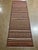 Handwoven Afghan Meymana kilim flatweave runner featuring a striped field with alternating horizontal bands of fine...