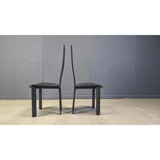 Set of 4 black Italian leather high back dining chairs. beautiful sleek and timeless design. The chairs are in good...