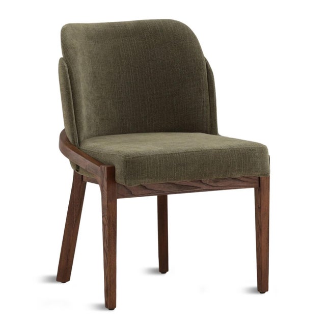 Upholstered contemporary dining chair which brings easy sophistication to any dining space. Beautiful grained walnut...