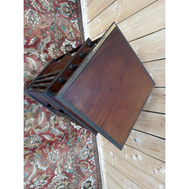 A Victorian revolving bookcase on casters, circa 1870-1900, crafted from solid mahogany with a reddish-brown hue and rich...