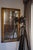 Striking vintage industrial spotlight mounted on an authentic military-style wood and metal tripod. Features an oversized...