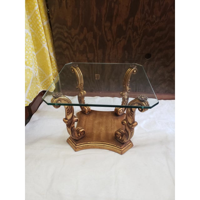 These glass end tables were built to bring an elegance to any living room. Their thick, flat-edged glass sits on gold...