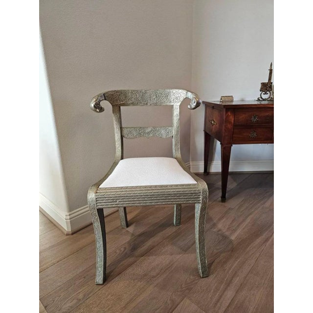 A striking vintage Anglo-Indian silvered metal-clad chair, 20th century, influenced by the dowry wedding chairs of Indian...