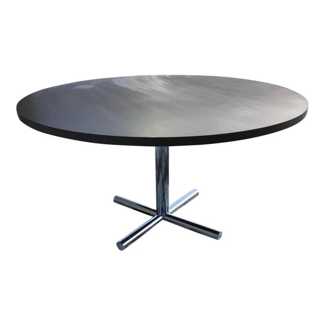 Large scale round walnut dining or conference table on solid round stock chromed steel pedestal and cast iron base manner...