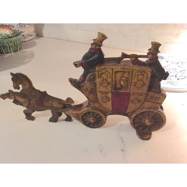 This is a cast iron (very heavy!) 2-sided door stop from the 1920s-30s. I believe this is the original paint so it has a...