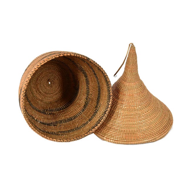 The Tutsi Tight Weave Basket with Lid from Rwanda epitomizes the artistry and tradition of the Tutsi community's weaving...