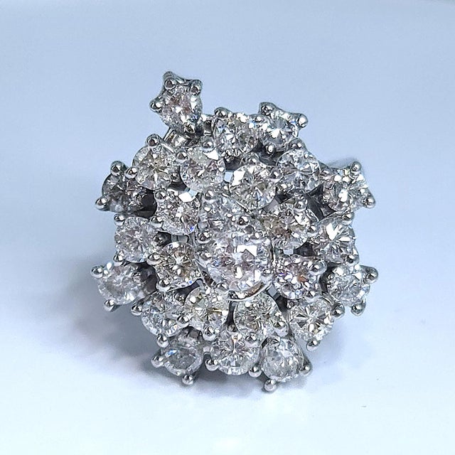 This is a large attention grabbing ring with a total of twenty six diamonds on display. - Stone Info - Round Diamonds 25x...