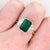 An emerald sits in a rich green at the heart of this solid 14K yellow gold ring, flanked by ten earth-mined diamonds....
