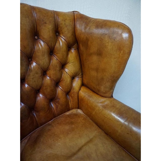 Vintage wood and leather Chesterfield armchair in a beautiful cognac leather color with a great patin. Typical high back...