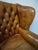 Vintage wood and leather Chesterfield armchair in a beautiful cognac leather color with a great patin. Typical high back...