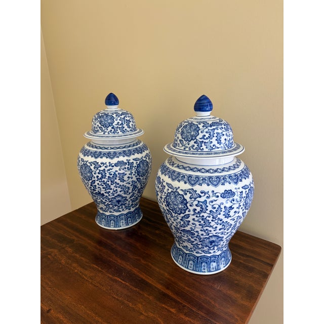 A classic pair of blue and white ginger jars, decorated throughout with delicate Chinoiserie floral motifs. The pattern is...