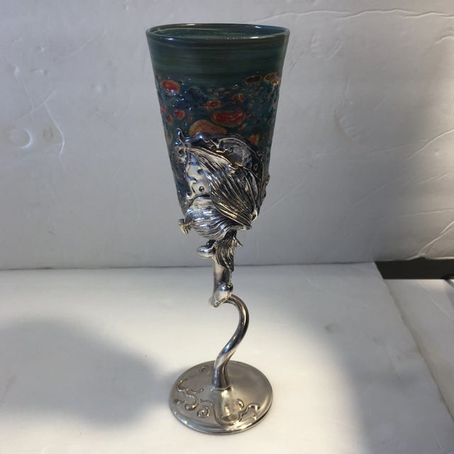 Thin and finely handblown multicolored glass goblet with decorative silvered metal stem. Has original sticker on...