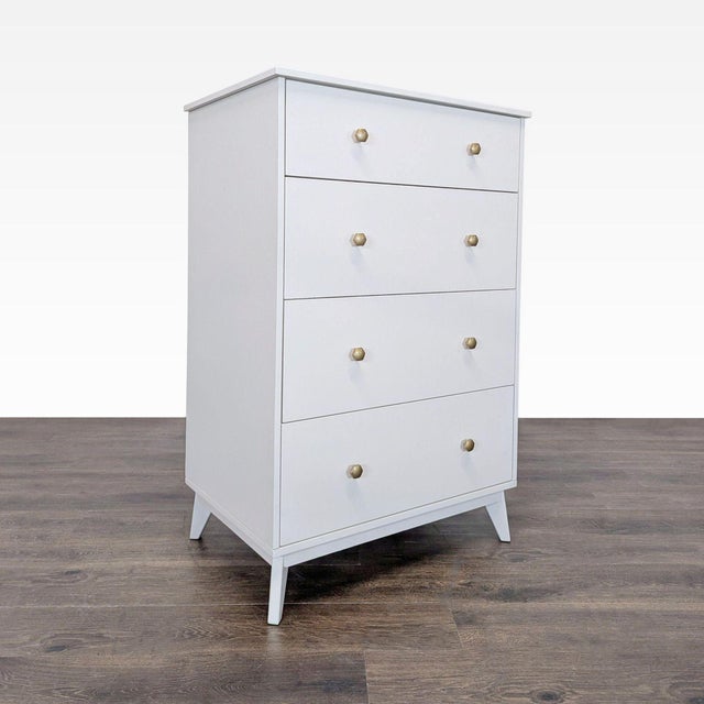 This Pottery Barn Teen dresser features a clean white finish with four spacious drawers and elegant gold knobs. Its sturdy...