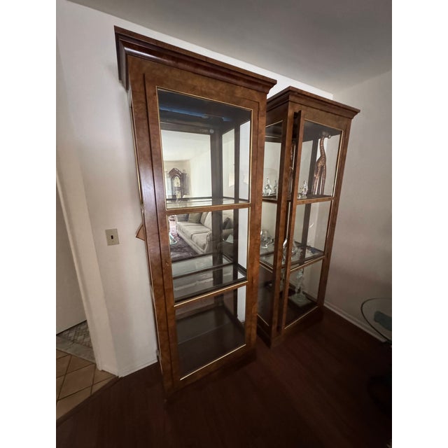 Add timeless elegance to your home with this stunning set of two Baker Furniture Collector's Edition curio display...
