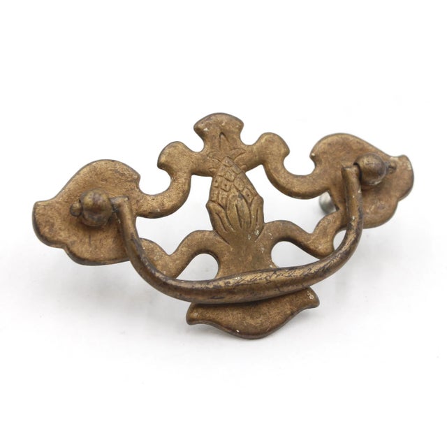 Pair of Vintage Chippendale dresser drawer pulls with cut out pineapple designs in an antique brass finish. The back plate...
