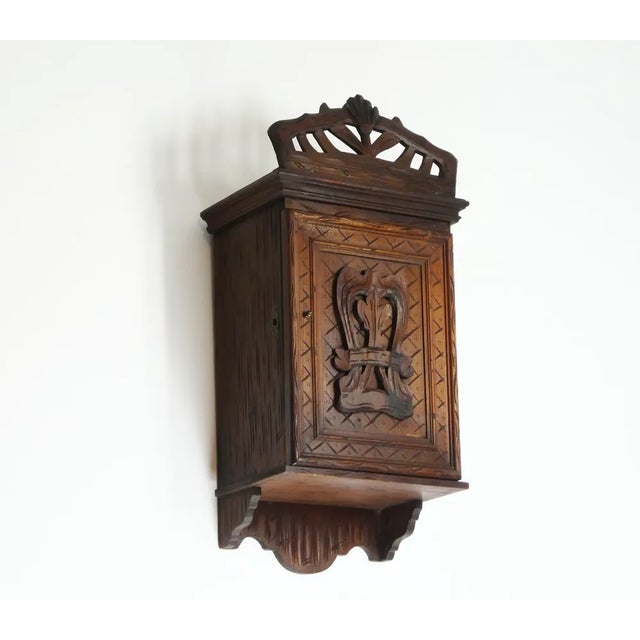 A very beautiful small antique hand carved wooden cabinet with amazing details all over and ornaments. The cabinet is...