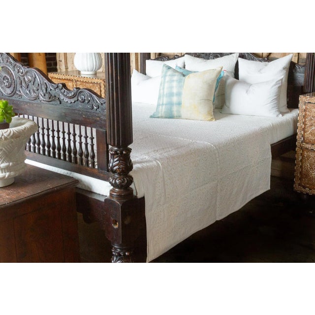 A lightweight cotton coverlet from Western India, beautifully adorned with decorative handcrafted applique cut work using...