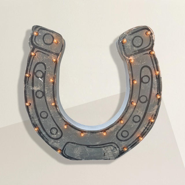 The horseshoe has always promised good luck. This one promises better stories. This vintage American gray painted...