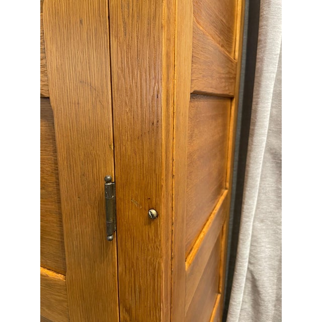 This is a wonderful natural oak cabinet with inset panels and two large doors which open to deep and wide shelving....
