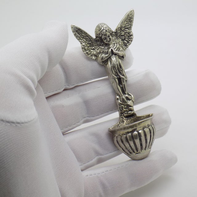 A finely handcrafted vintage wall-mounted holy water font, featuring an angelic figure, made in Italy during the 1970s and...